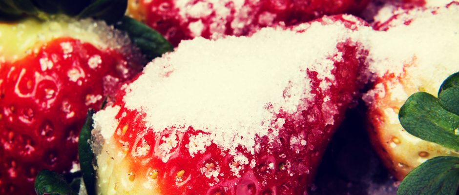Close up on fresh red strawberries with sugar.