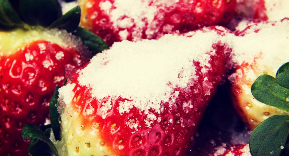 Close up on fresh red strawberries with sugar.